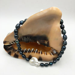 Black pearl with large white baroque pearl accent